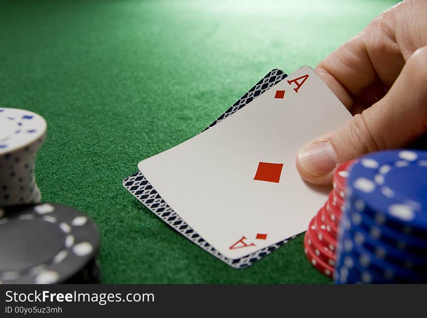 Blackjack hand with Ace of diamonds and gambling chips on a green felt table.