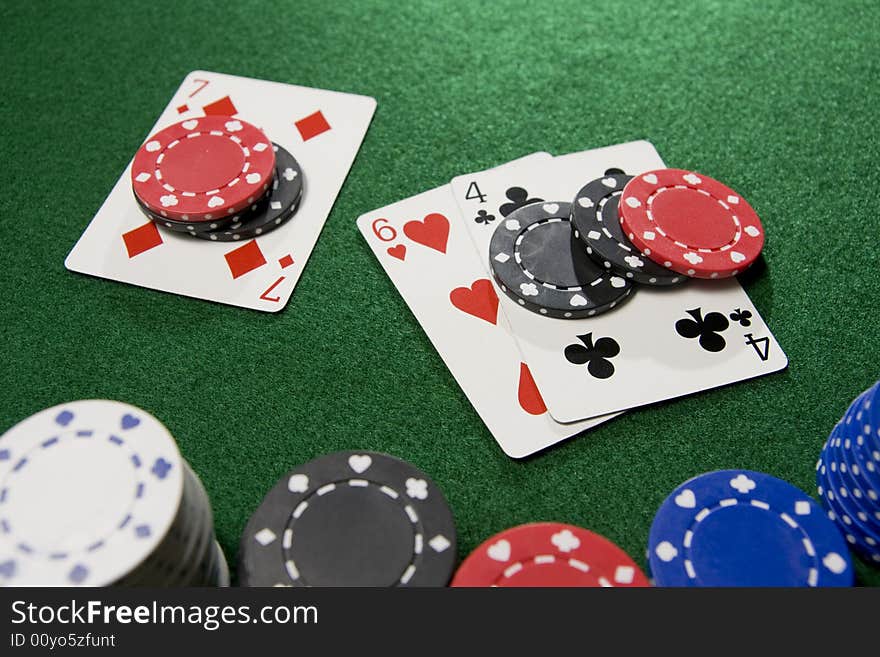 Blackjack hand doubled with Seven, Six, and Four.  Gambling chips scattered over a green felt table.