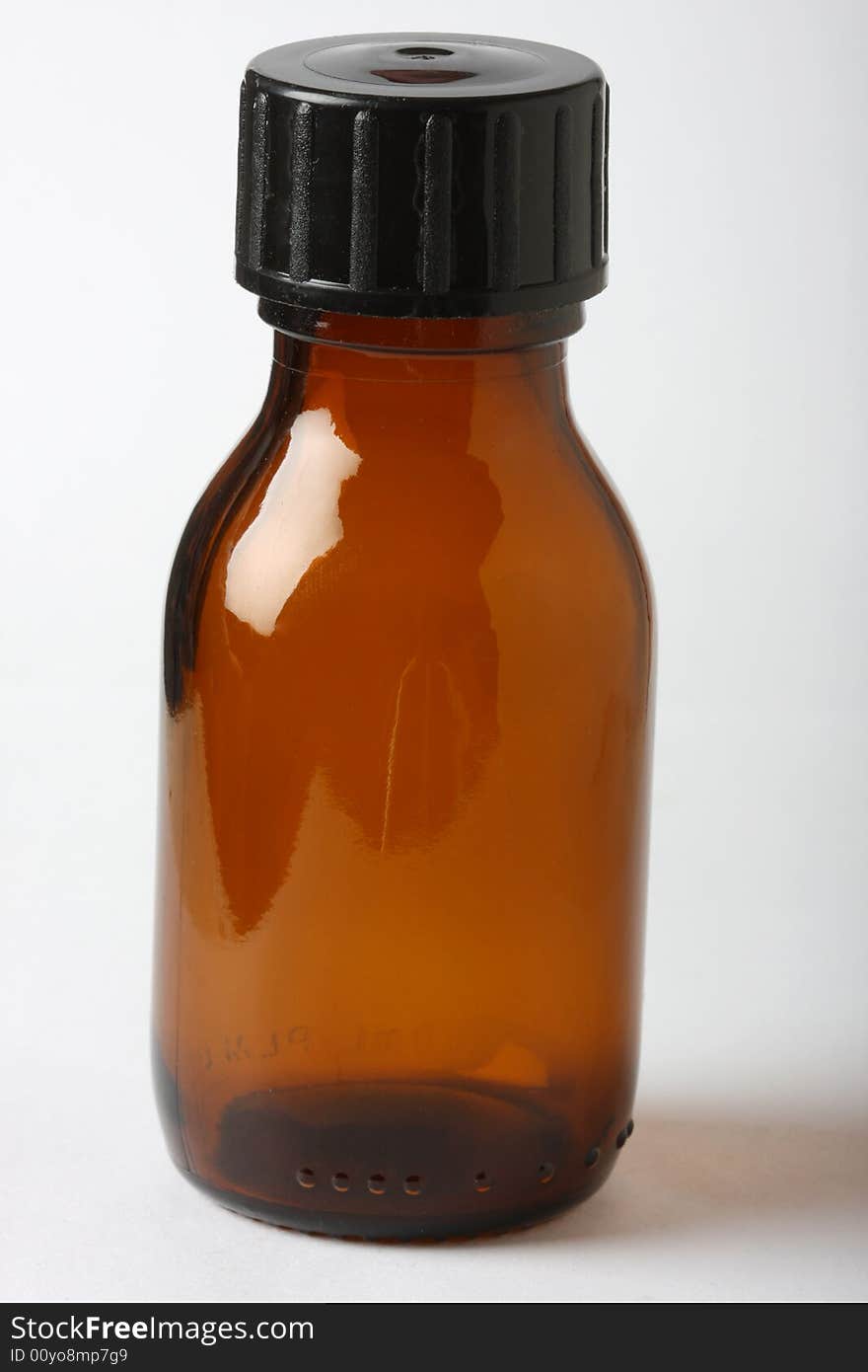 Small brown medicine bottle shot in studio. Small brown medicine bottle shot in studio