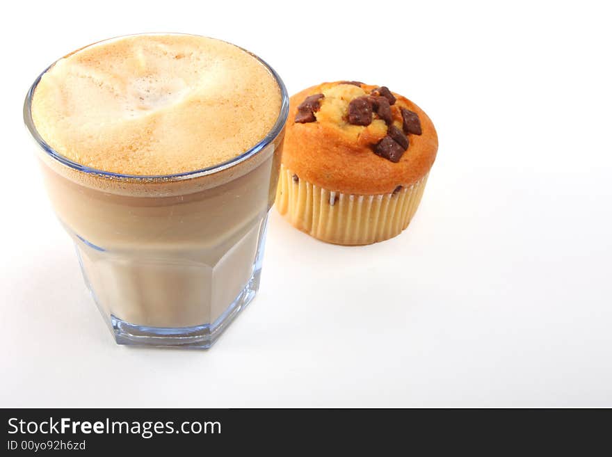 A shot of a a cup of coffee with muffins. A shot of a a cup of coffee with muffins