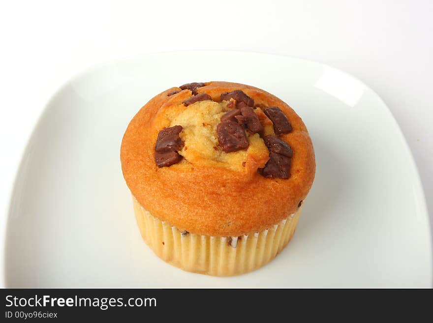 Cupcake on white dish, isolated on white shot in studio. Cupcake on white dish, isolated on white shot in studio