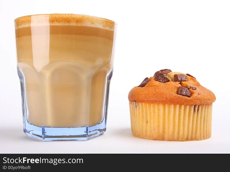 Cafe aulait in a glass with chocolate muffin, isolated on white. Cafe aulait in a glass with chocolate muffin, isolated on white