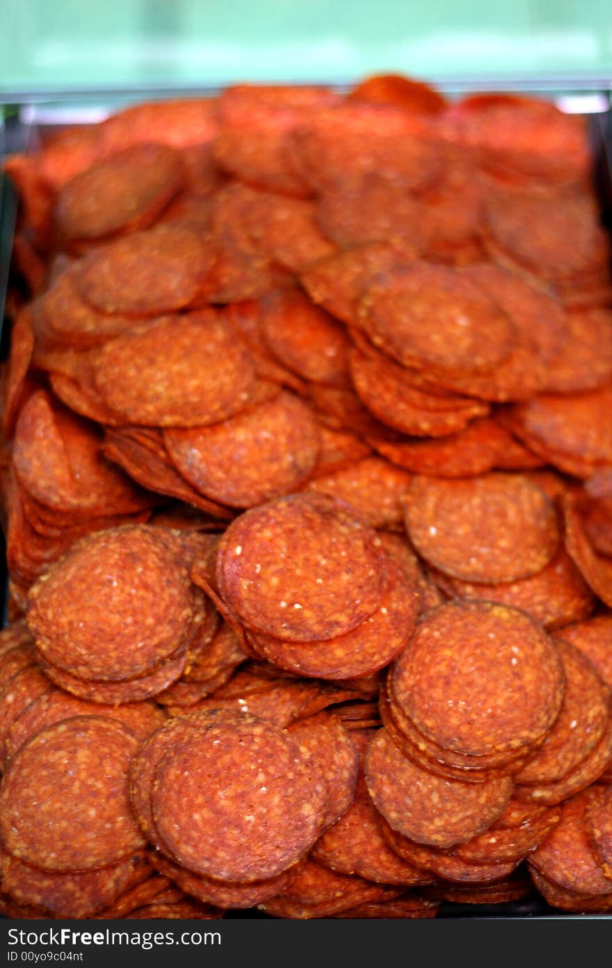 A sliced pepper salami behind the shop-window. A sliced pepper salami behind the shop-window