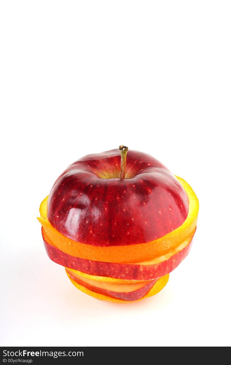 Slices of apple and orange put together to form one fruit shot on white in studio. Slices of apple and orange put together to form one fruit shot on white in studio