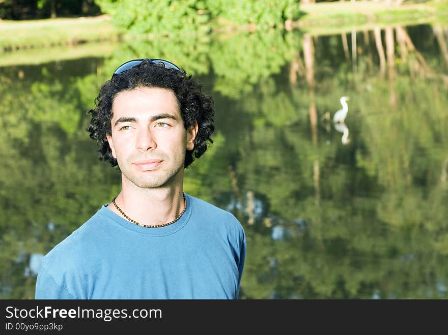 Man Standing in front of Pond - Horizontal