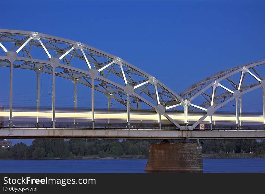 The night express train on the bridge across Daugava river. The night express train on the bridge across Daugava river.