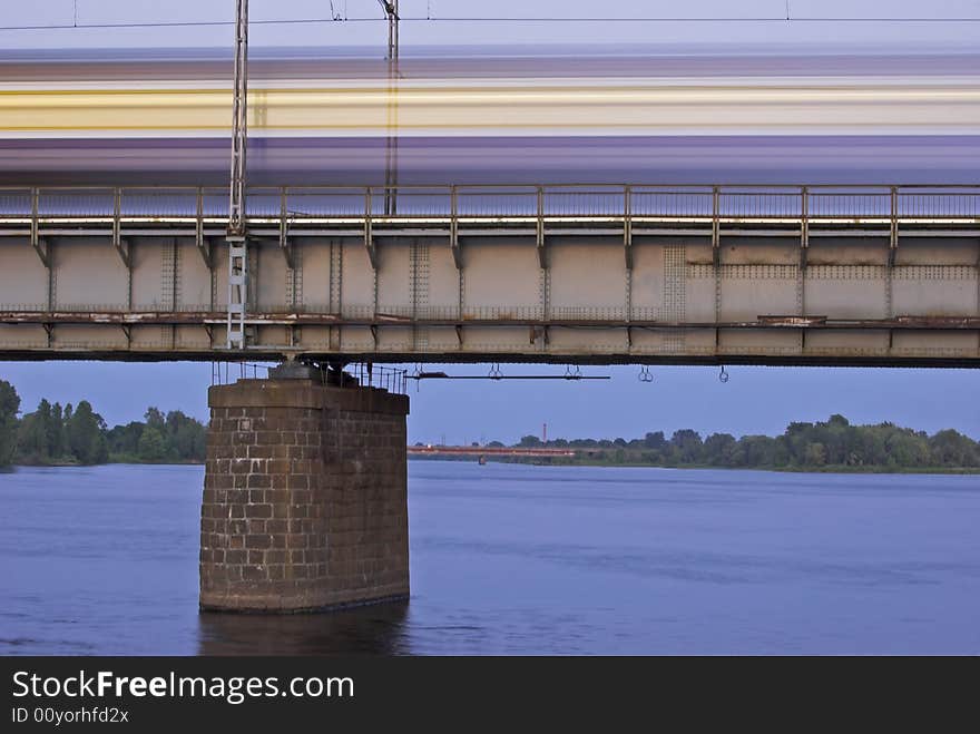 The morning express train on the bridge across Daugava river. The morning express train on the bridge across Daugava river.