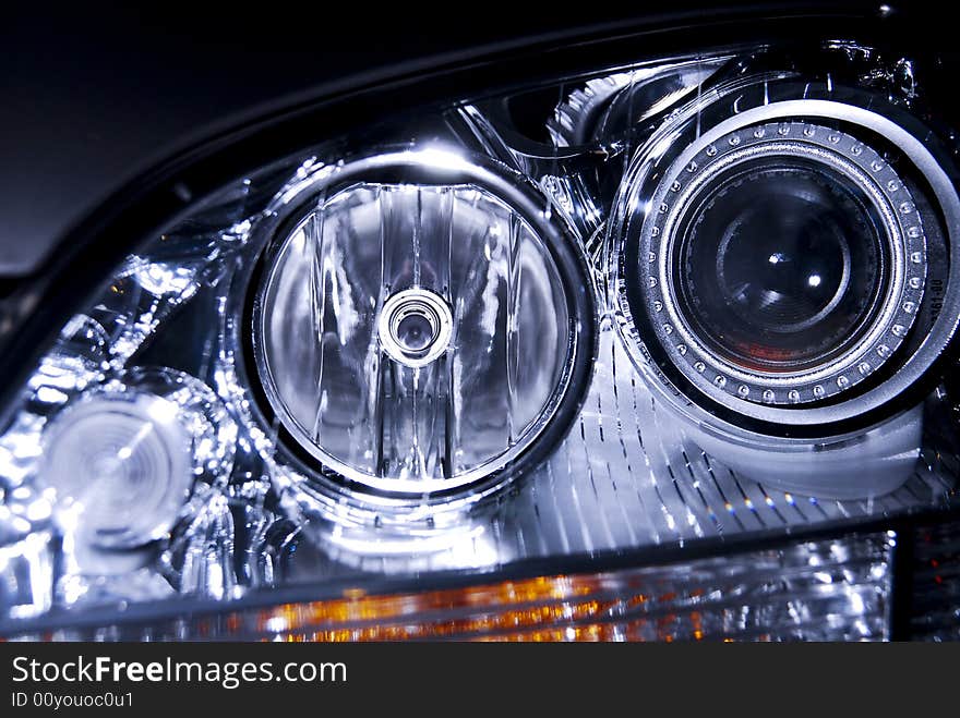 Close-up of a luxurious SUV headlight showing much detail. Close-up of a luxurious SUV headlight showing much detail