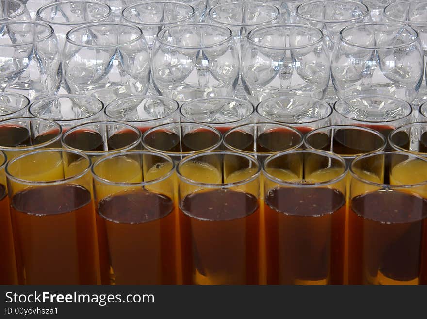 Empty wine glasses and full glasses of fruit juice. Empty wine glasses and full glasses of fruit juice