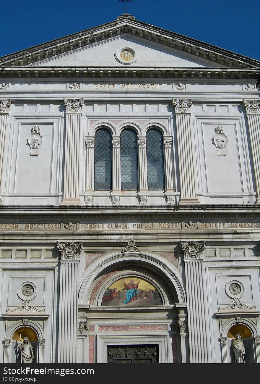 Portal of Catholic cathedral against clear blue sky in Italian village