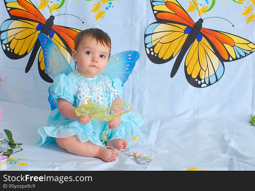 A picture of a sweet little girl in a fancy blue dress with butterfly wings. A picture of a sweet little girl in a fancy blue dress with butterfly wings