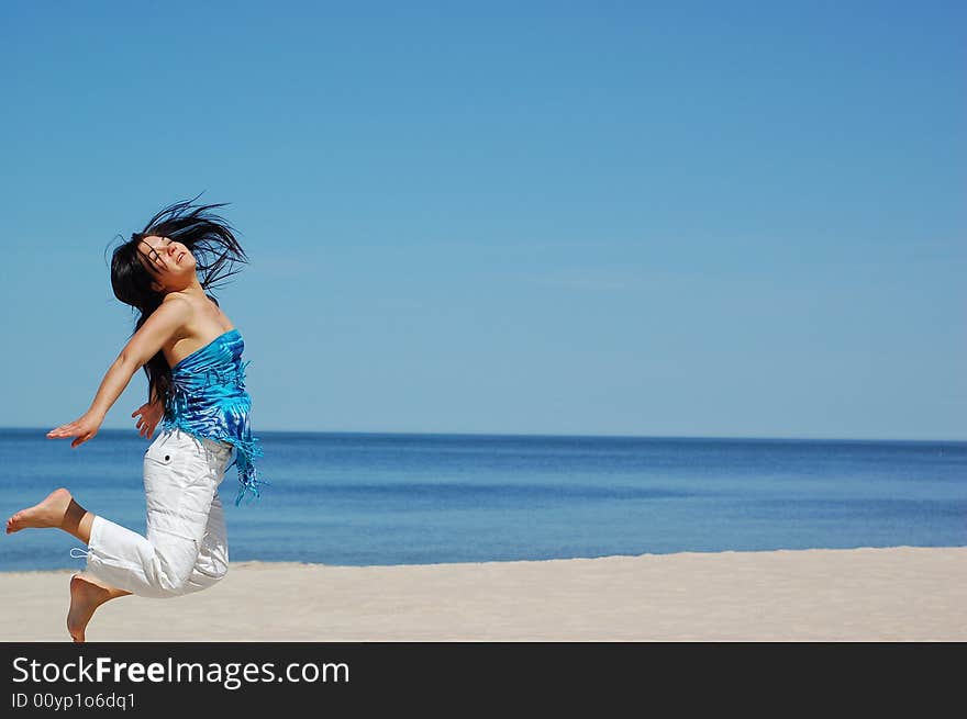 Active woman jumping on the beach. Active woman jumping on the beach