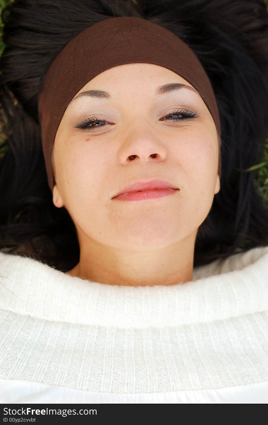 Attractive woman lying on green grass. Attractive woman lying on green grass