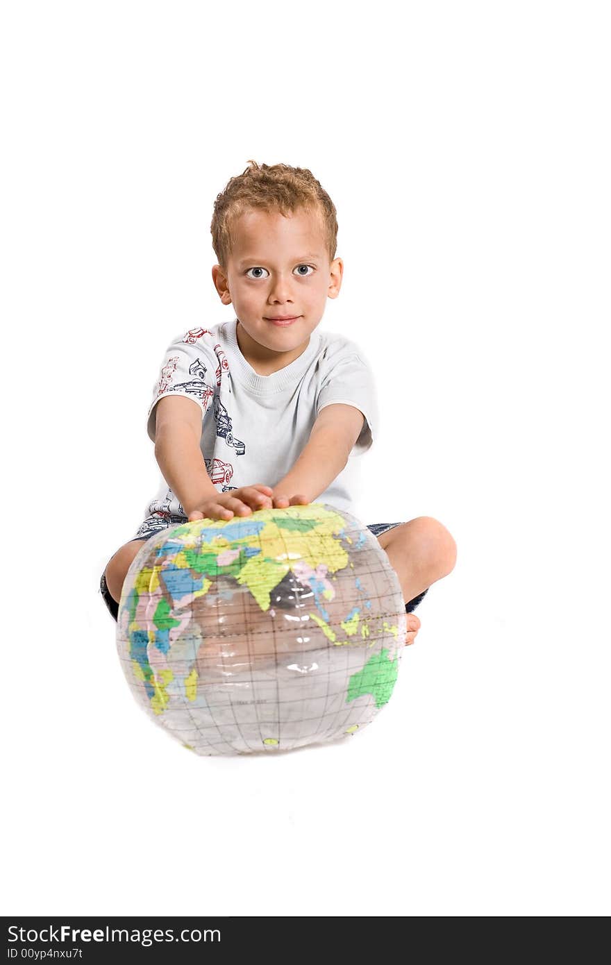 Young boy plays with globe - isolated on white