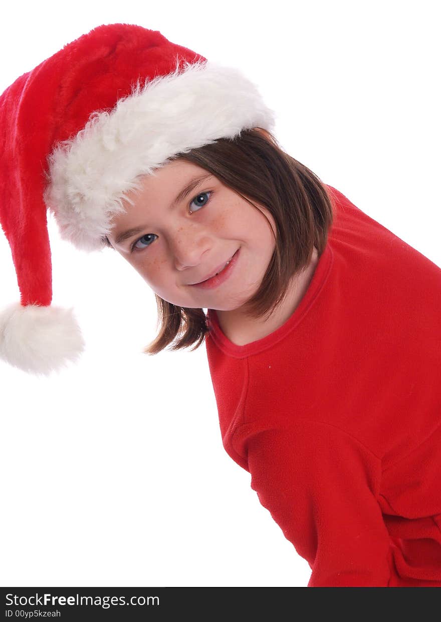 School aged girl wearing red shirt and Santa hat, perfect for the Christmas season. School aged girl wearing red shirt and Santa hat, perfect for the Christmas season