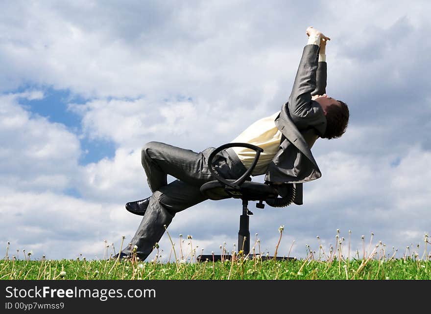 The young businessman sitting on a chair. The young businessman sitting on a chair