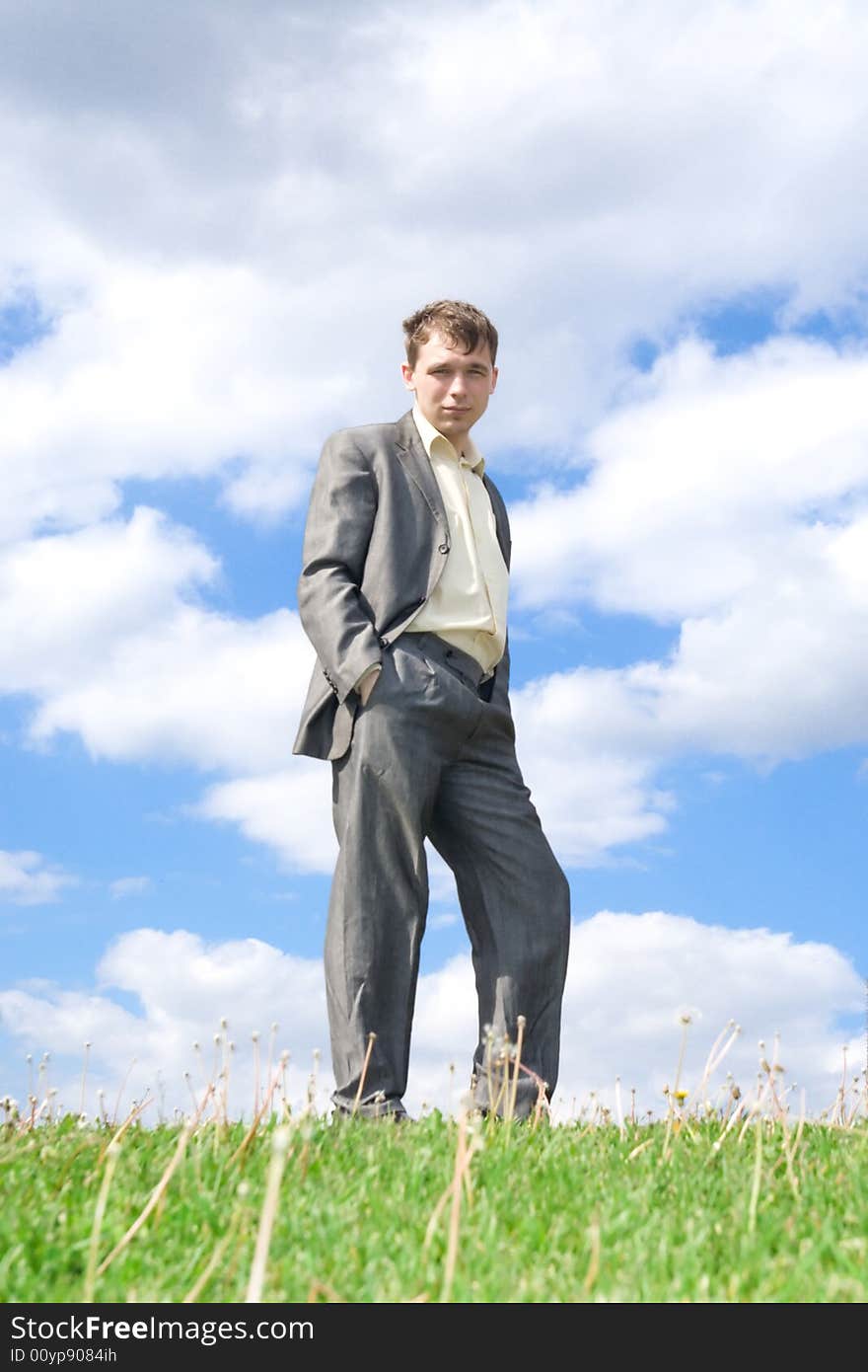 The Businessman Standing On A Green Grass