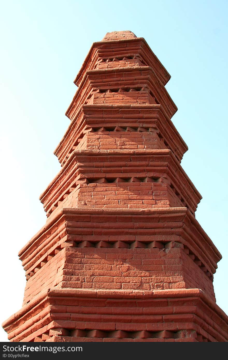 Red brick pagoda on background of sky