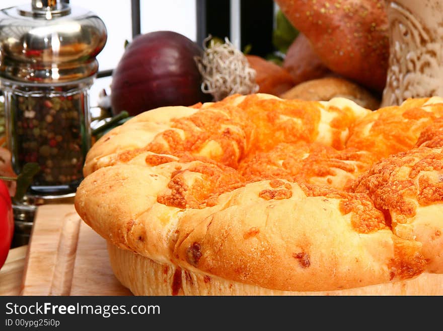 Fresh baked cheddar cheese roll loaf in kitchen or restaurant setting. Fresh baked cheddar cheese roll loaf in kitchen or restaurant setting.