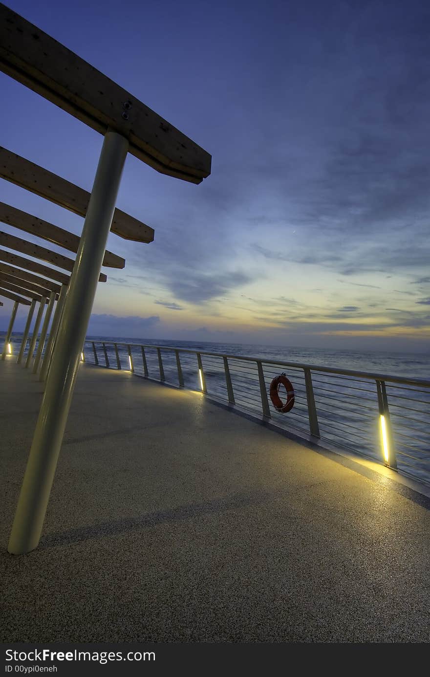 Modern building at the end of a brand new pier photograhed at dusk in tuscany, Italy. Modern building at the end of a brand new pier photograhed at dusk in tuscany, Italy