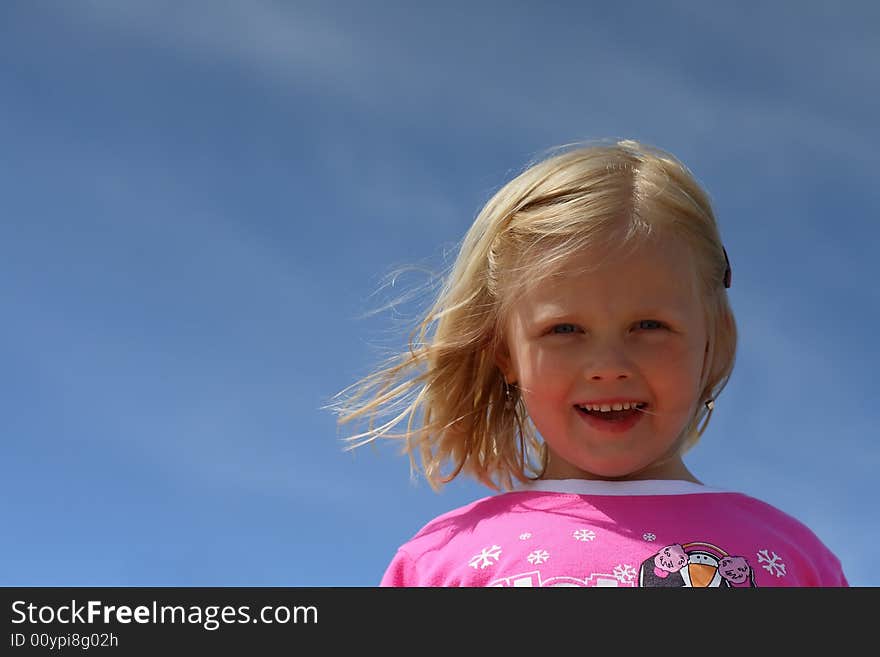 Portrait of smiling girl  over blue sky. Portrait of smiling girl  over blue sky