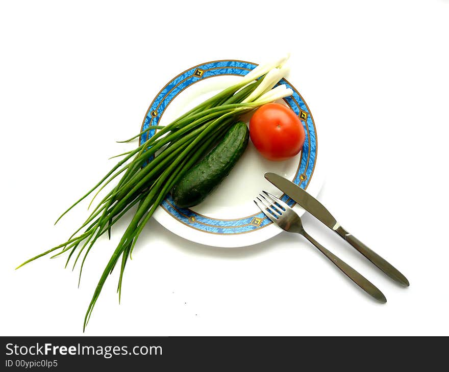 Green onion, cucumber and tomato on the plate. Green onion, cucumber and tomato on the plate