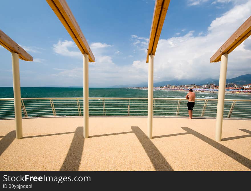 Iew of the coastline of versilia, 20 kilometers of beach in the north of tuscany near Liguria, from a modern pier. Iew of the coastline of versilia, 20 kilometers of beach in the north of tuscany near Liguria, from a modern pier.