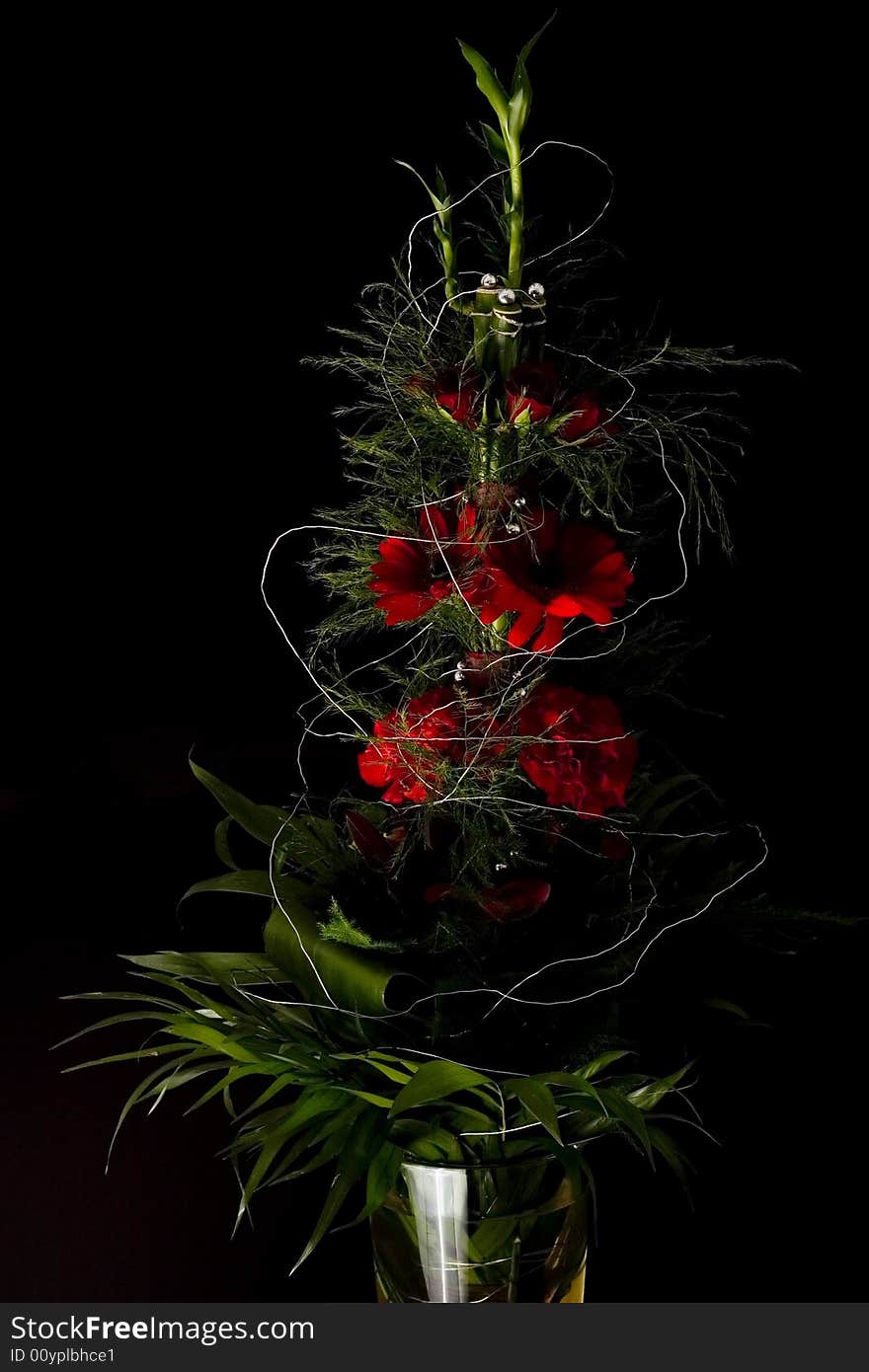 Red flowers bouquet isolated on black with selective lighting