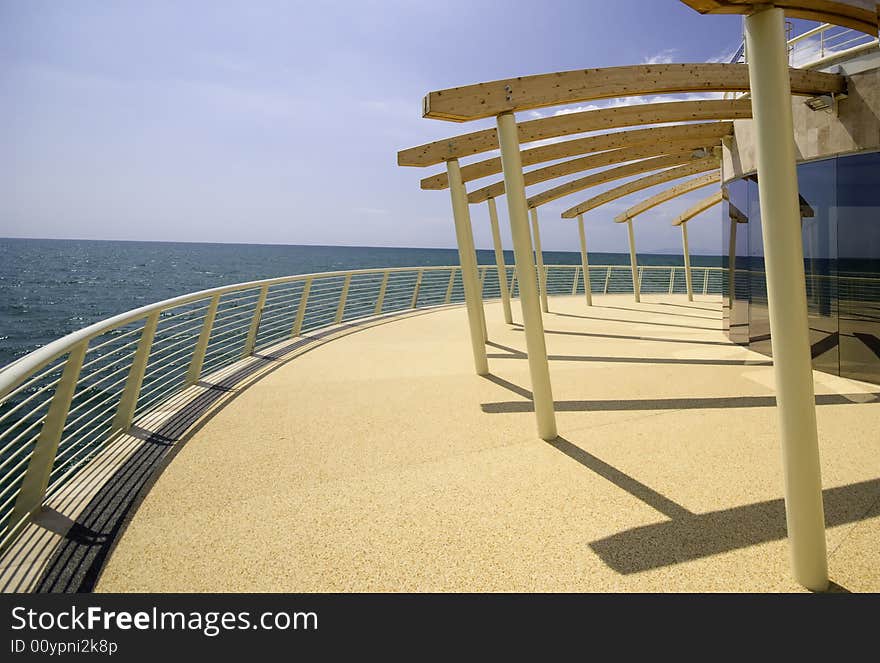 Modern architecture on boardwalk by blue sea in summer. Modern architecture on boardwalk by blue sea in summer.