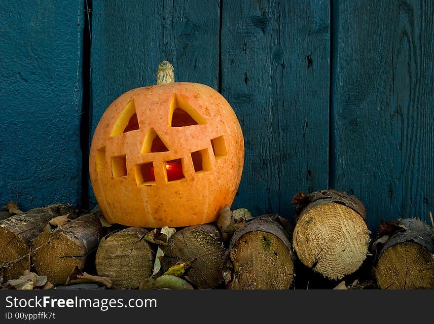 Orange pumpkin against a blue wood wall. Orange pumpkin against a blue wood wall