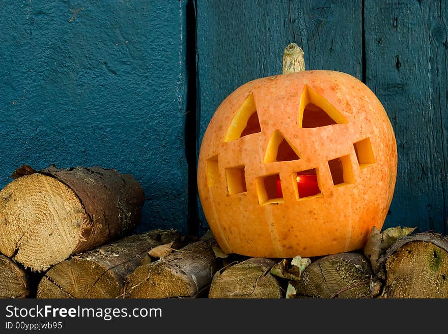 Orange pumpkin against a blue wood wall. Orange pumpkin against a blue wood wall