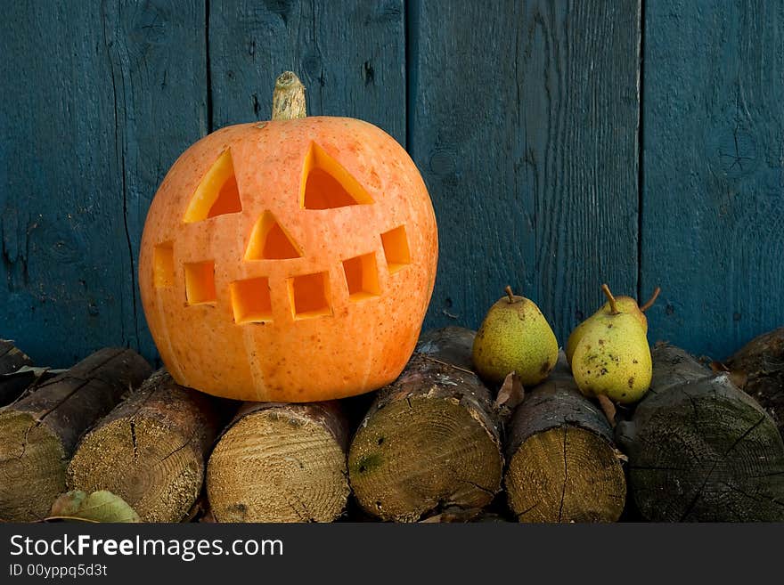 Orange pumpkin against a blue wood wall. Orange pumpkin against a blue wood wall