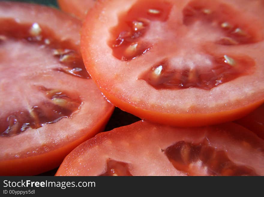 A close up view of slices of roma tomatoes