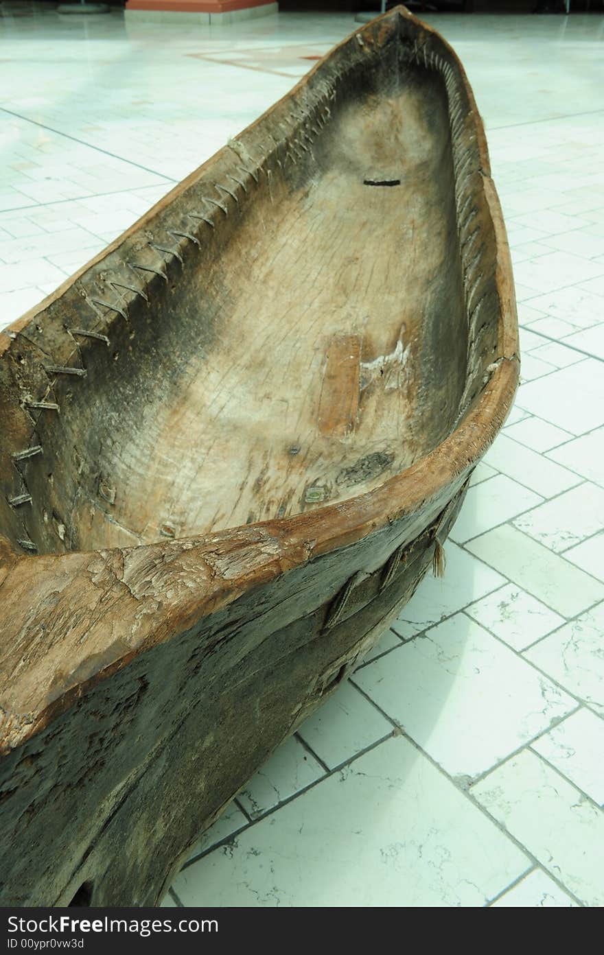 A very old, possibly antique, kayak or canoe, made from a solid tree trunk. A very old, possibly antique, kayak or canoe, made from a solid tree trunk.