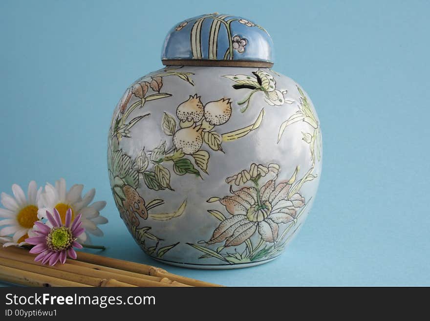 Chinese jug with tap in blue background