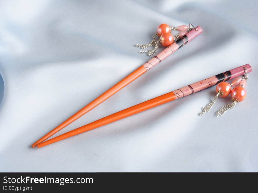 Orange geisha hairpins on blue satin material. Orange geisha hairpins on blue satin material