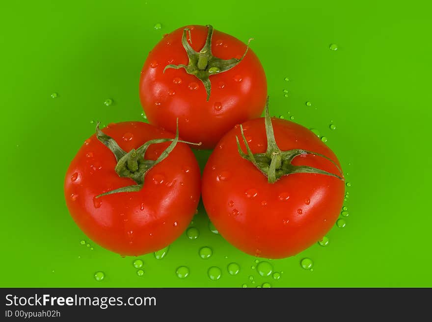 Three Tomatoes On Green