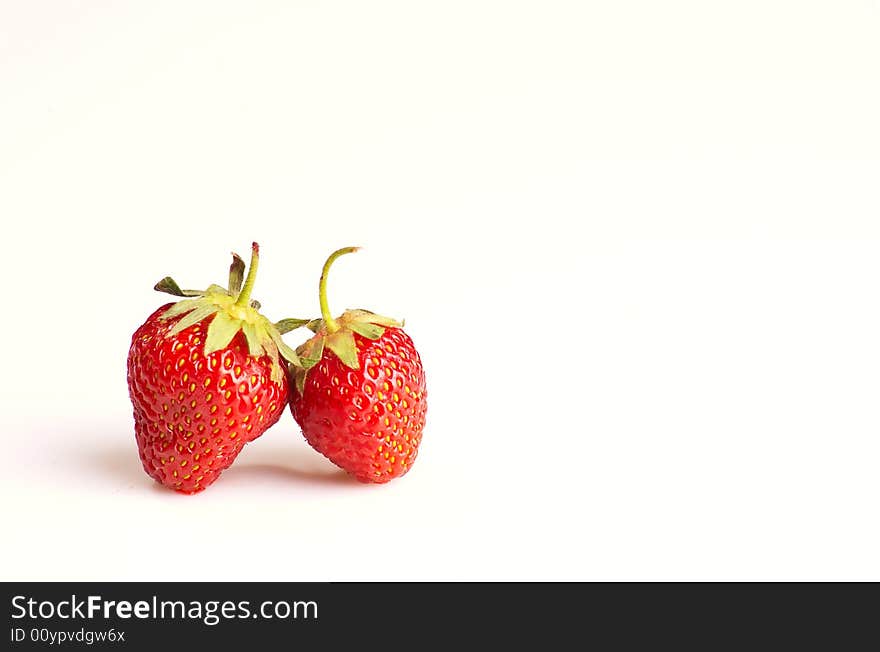 Two strawberries on white background, lots of copy space