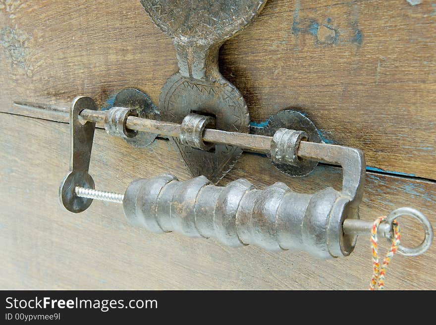 Antique locking mechanism or padlock on a restored antique chest with a hinged bracket lock.