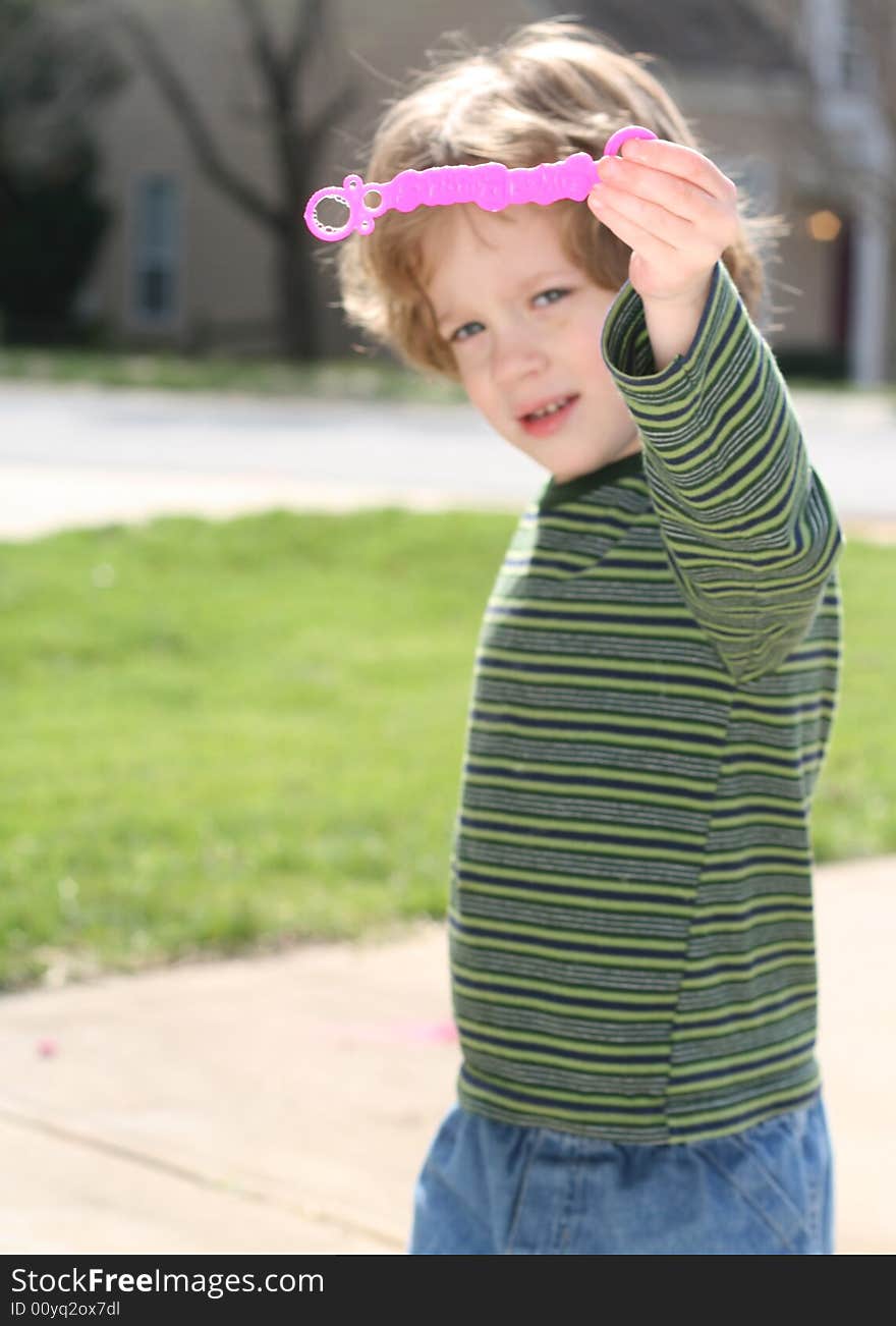 Four year old boy blowing bubbles