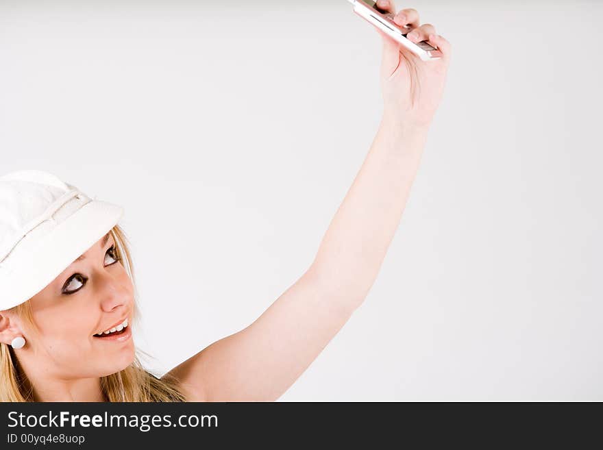 Young blond girl is busy with her cell phone. Young blond girl is busy with her cell phone