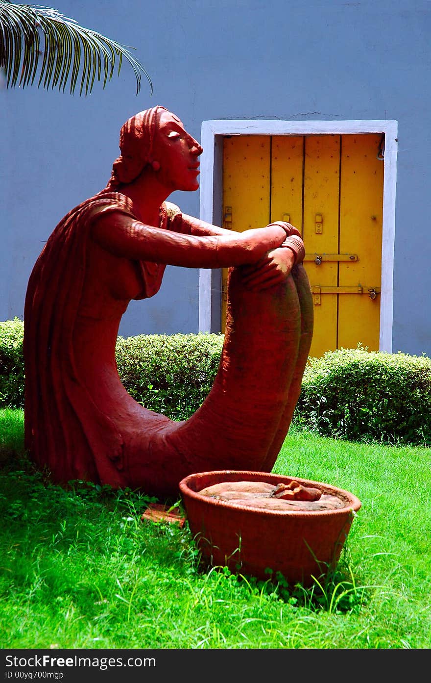 The sculpture of a young woman on road side of Goa town. The sculpture of a young woman on road side of Goa town.