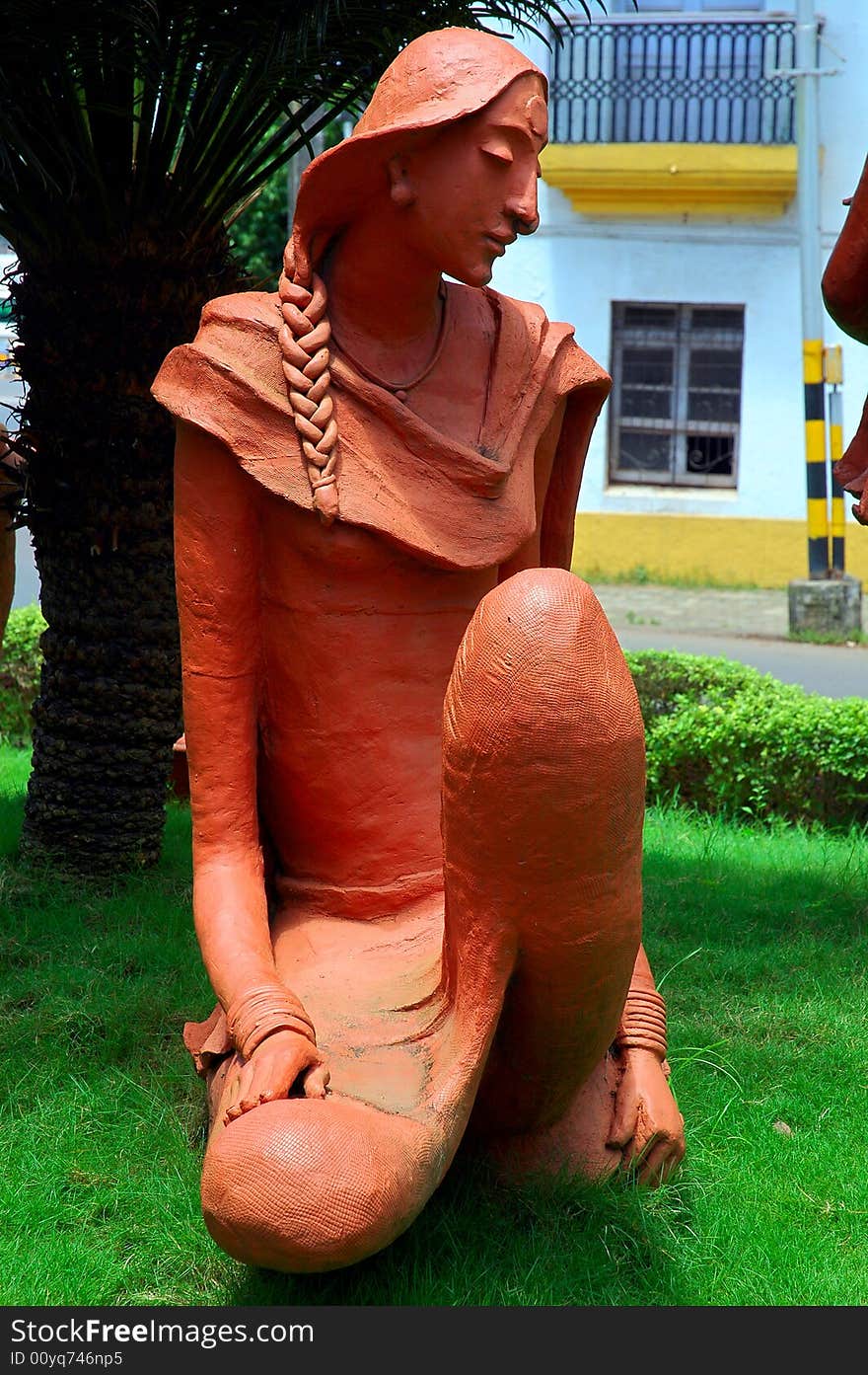 The sculpture of a young woman on road side of Goa town. The sculpture of a young woman on road side of Goa town.