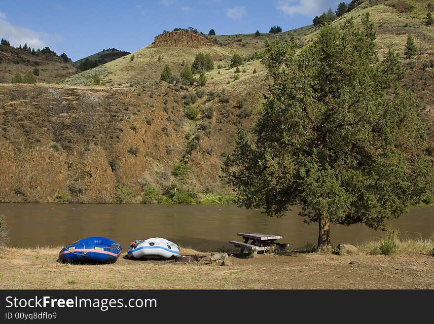 Two rafts beached on the shore of a river in Oregon. Two rafts beached on the shore of a river in Oregon