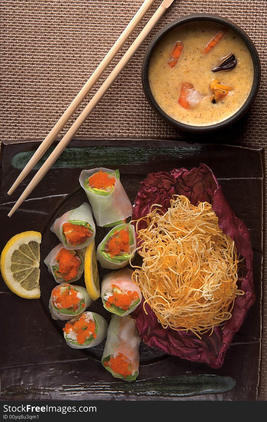 A view looking down on a complete Japanese meal including chopsticks.