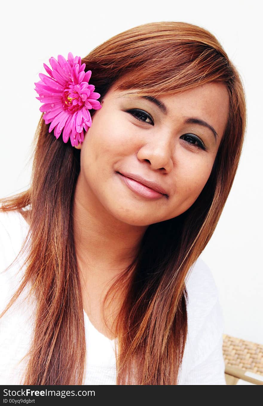 Portrait of a beautiful young Thai woman with a flower in her hair. Portrait of a beautiful young Thai woman with a flower in her hair.