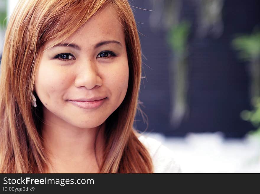 Portrait of a beautiful young Thai woman with a flower in her hair. Portrait of a beautiful young Thai woman with a flower in her hair.