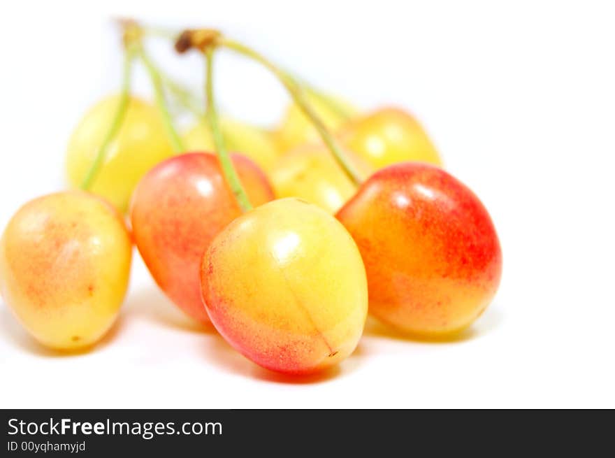 Light orange cherries isolated on white