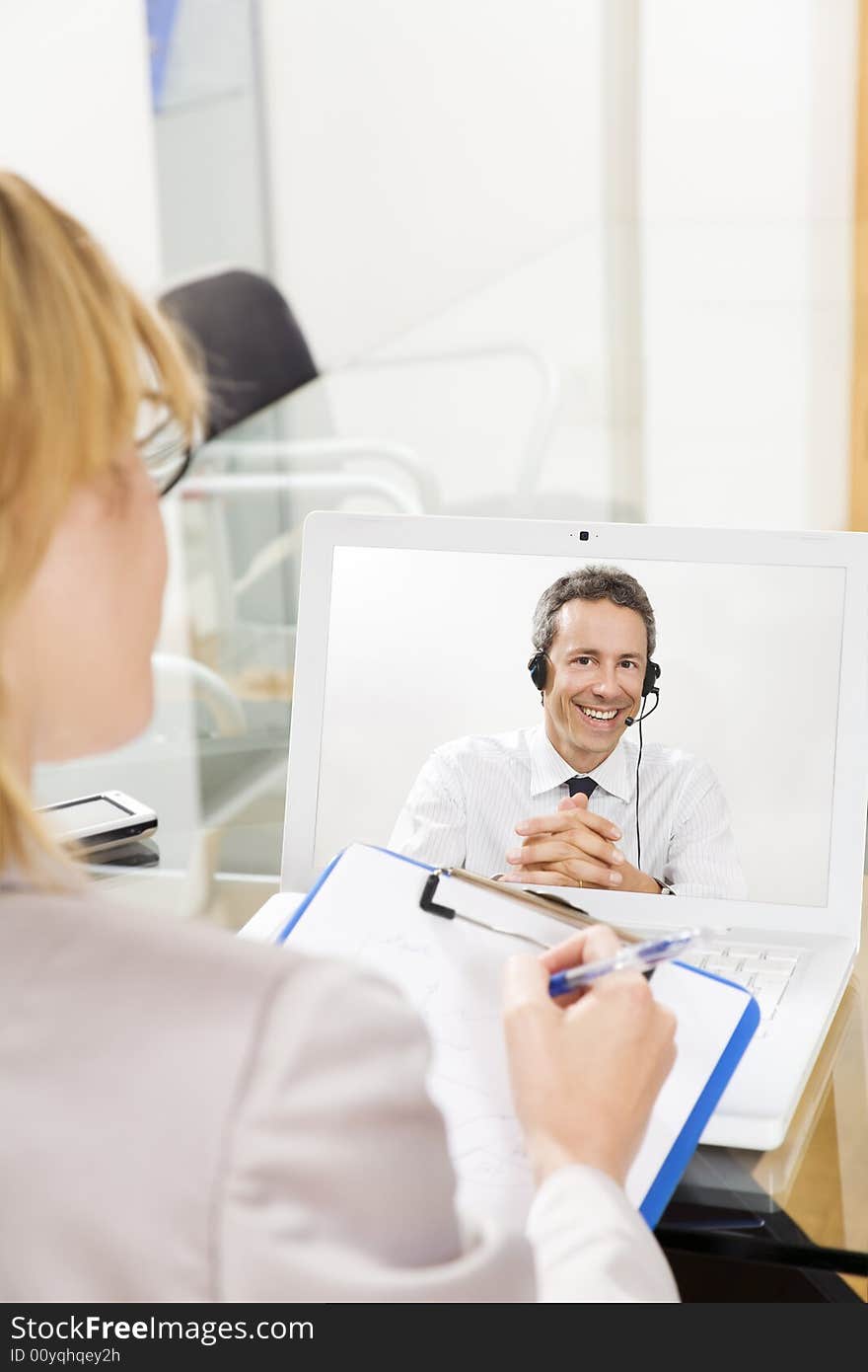 Businessman having laptop conference call with colleague. Businessman having laptop conference call with colleague.