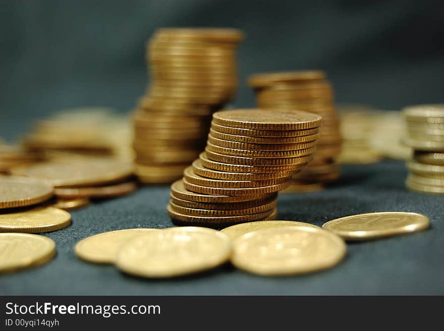 A pile of golden coins on dark background. A pile of golden coins on dark background